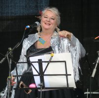 Bev on stage performing with her band