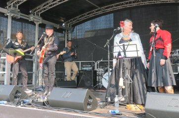 Bev on stage performing with her band